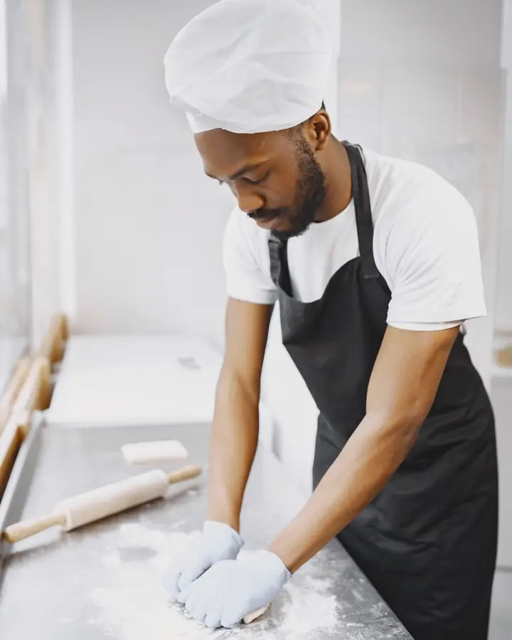 A baker kneading dough