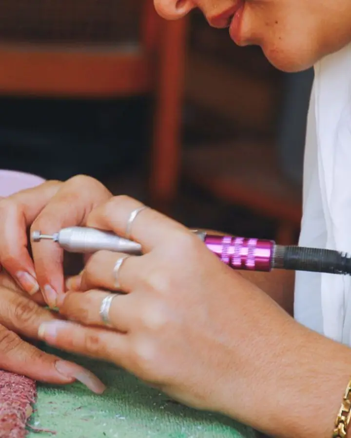 A nail technician at work